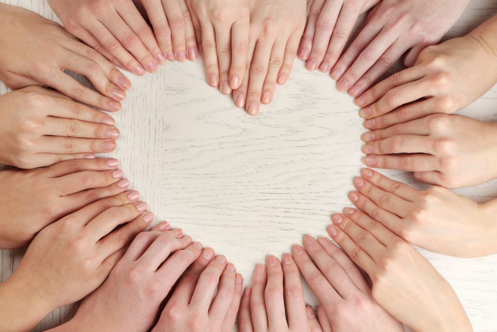 lot fingers making heart shape wooden background 1 scaled